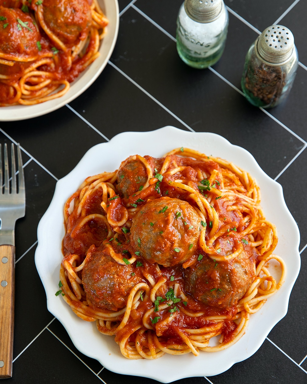 Vegan tofu meatballs served over spaghetti with marinara sauce