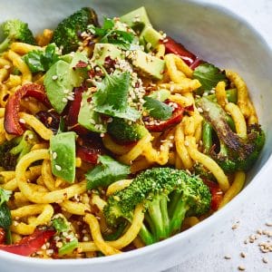 Vegan curry udon noodles with broccoli and avocado
