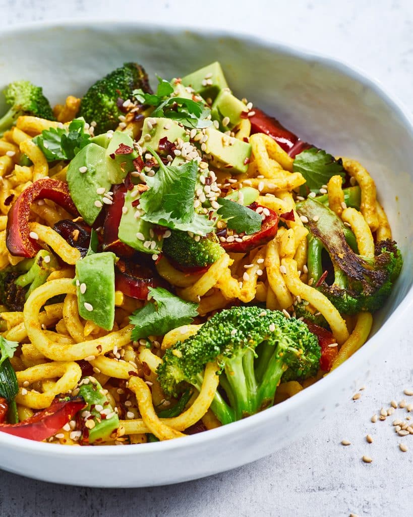 Vegan curry udon noodles with broccoli and avocado