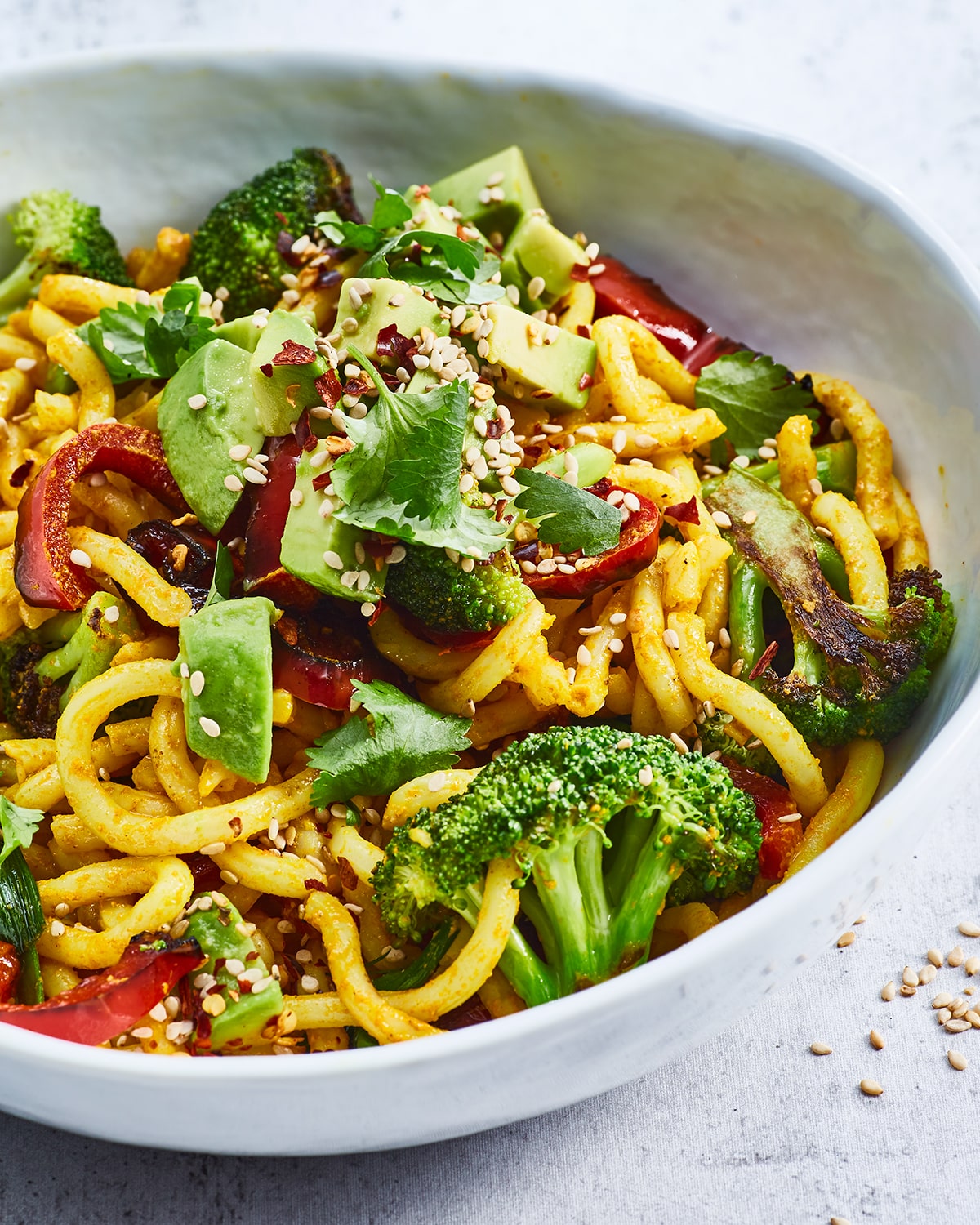 Vegan curry udon noodles with broccoli and avocado