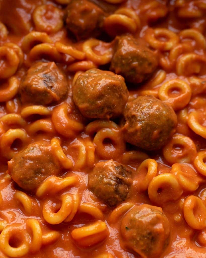 Vegan spaghettios swimming in a luscious tomato sauce and full of yummy mini lentil meatballs