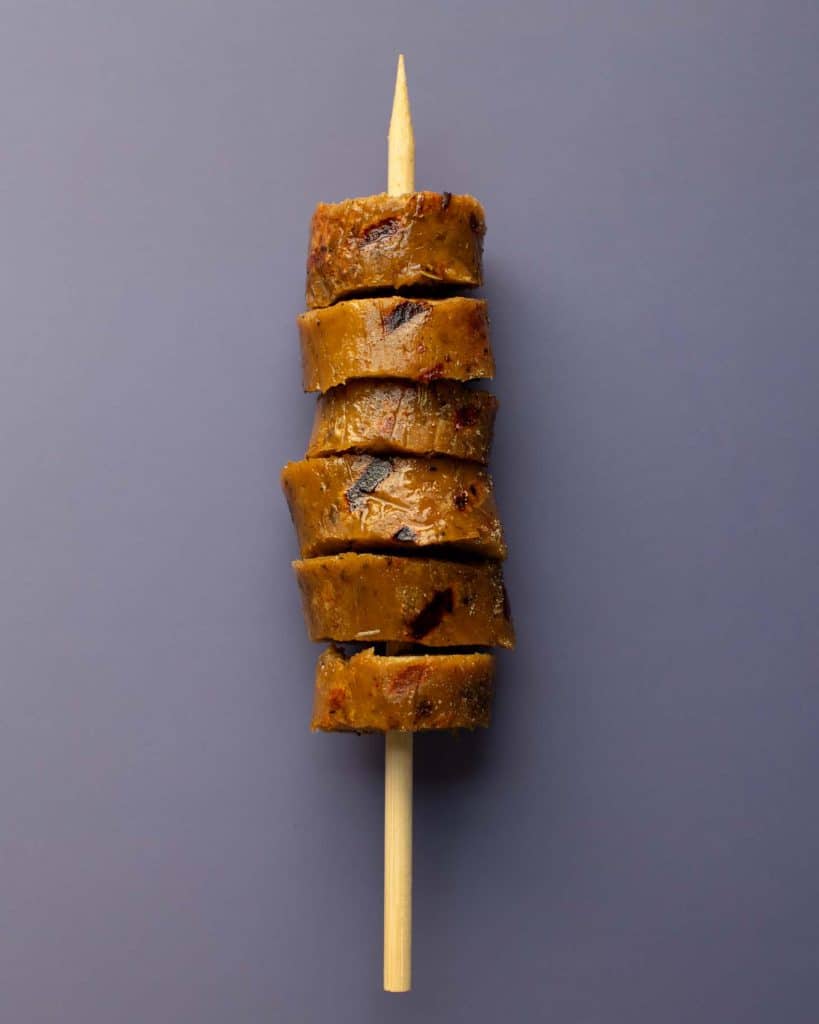 A vegan Italian sausage on a skewer
