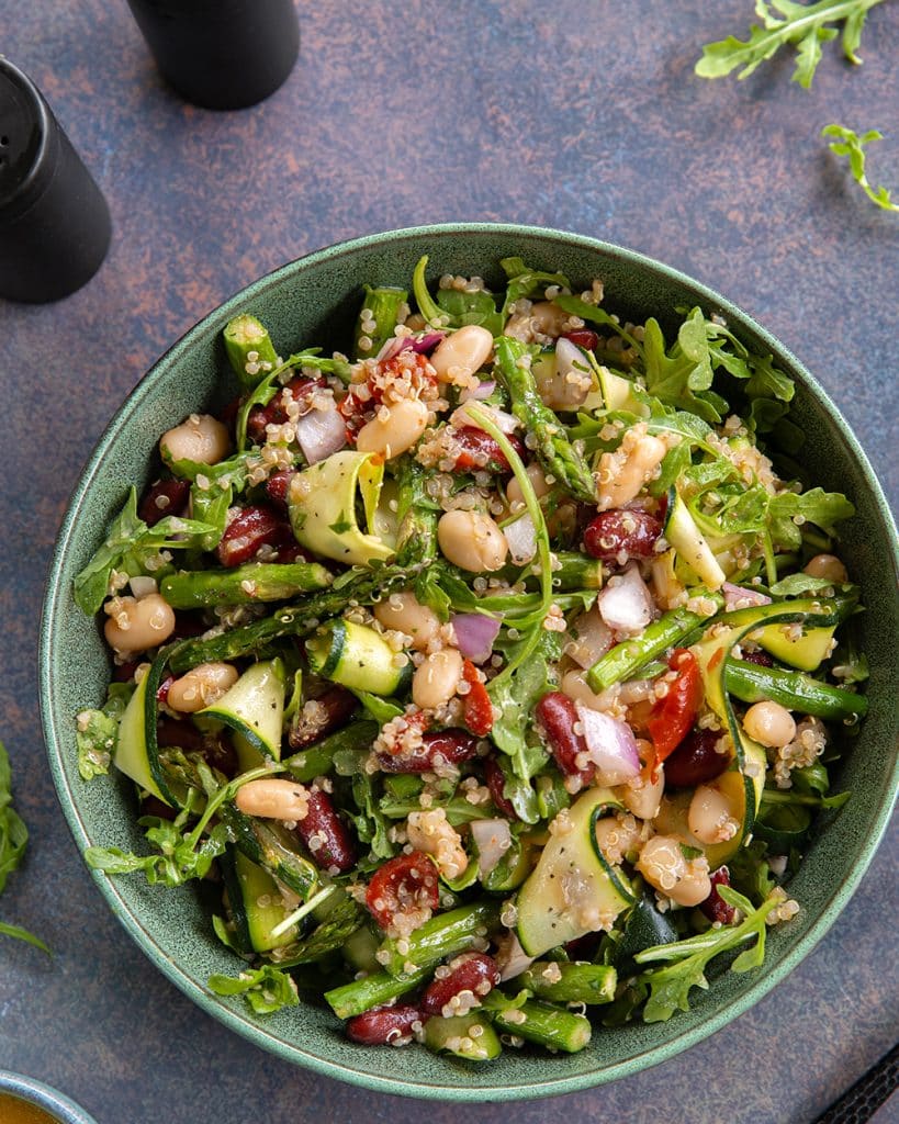 Vegan bean salad with two kinds of beans, asparagus, zucchini and arugula