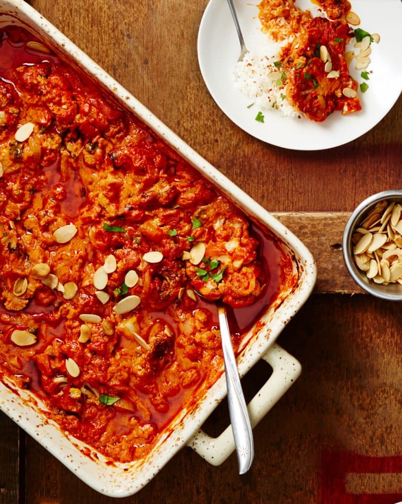Vegan cauliflower tikka masala with rice and toasted almonds