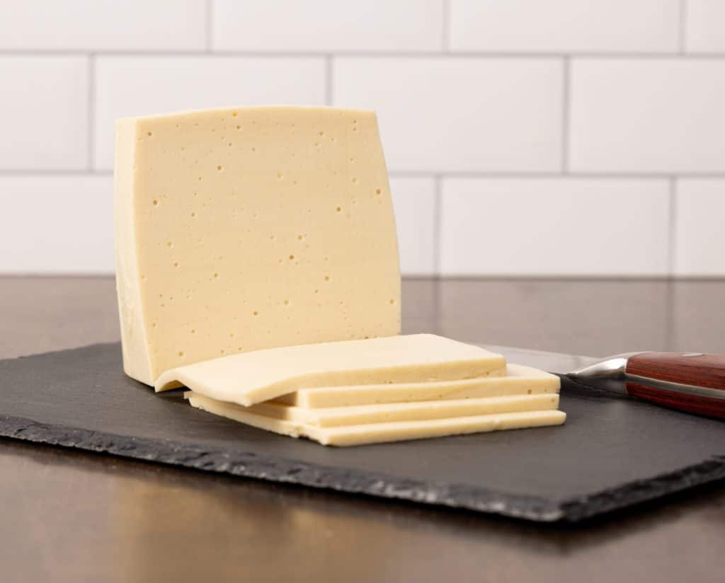 Sliced vegan provolone cheese recipe made with cashews