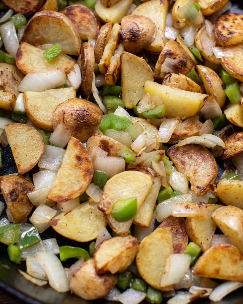 Close up of Brooklyn diner style home fries with peppers and onions