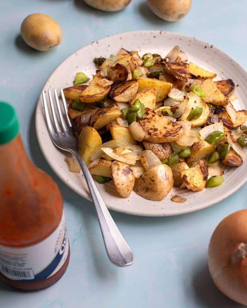 Brooklyn diner home fries with green bell peppers and onions with hot sauce