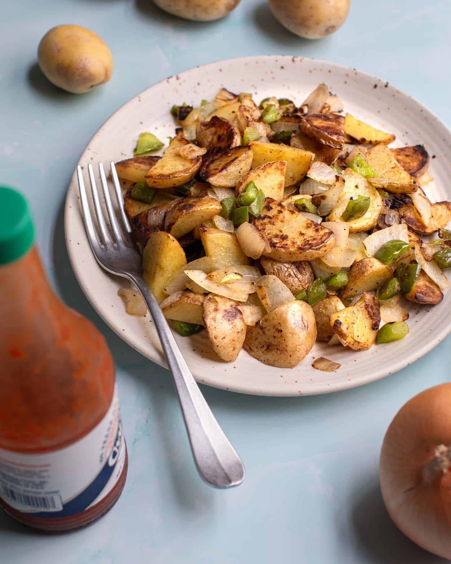 Brooklyn diner home fries with green bell peppers and onions with hot sauce