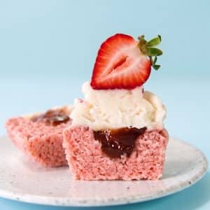 Vegan strawberry cupcakes filled with jam and topped with vegan buttercream