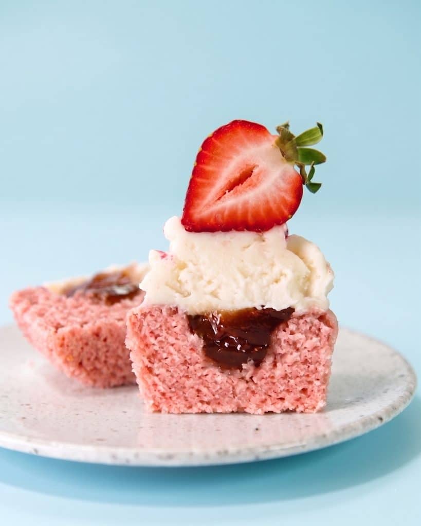 vegan strawberry cupcakes recipe, cut in half to show the pretty jam