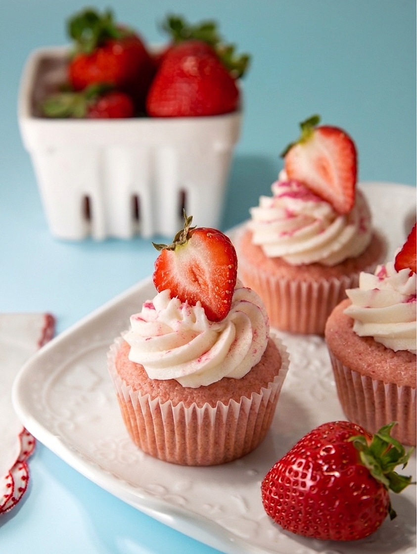 vegan strawberry cupcakes recipe, cut in half to show the pretty jam