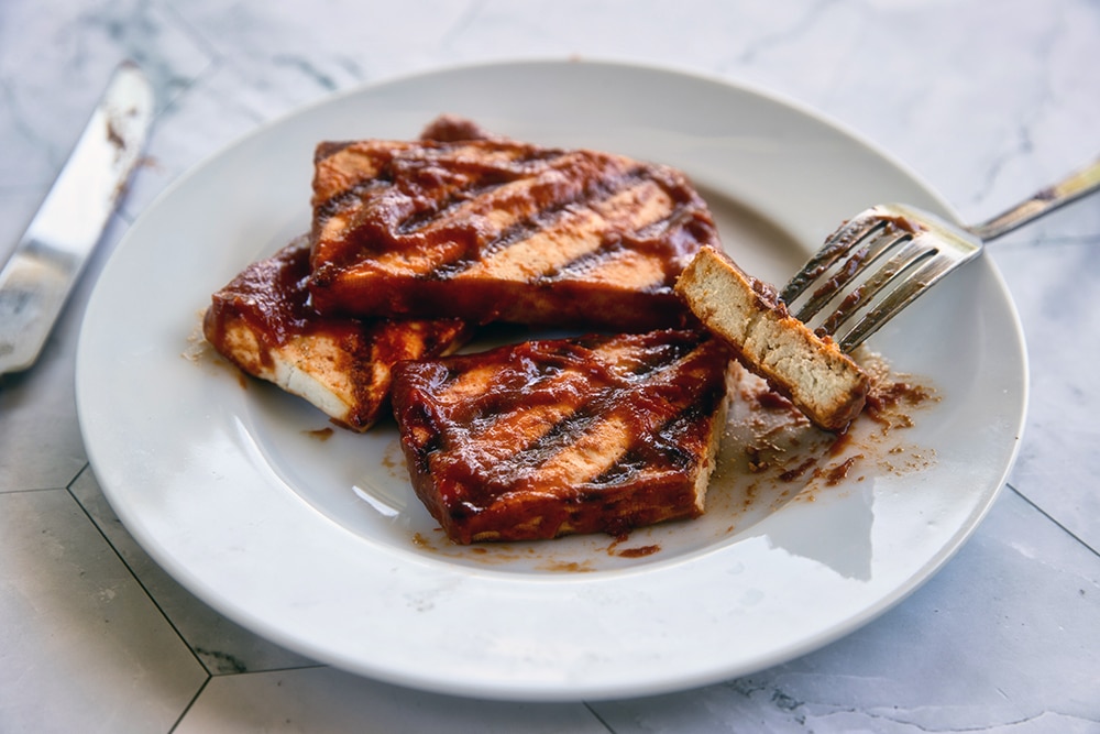 Barbecue tofu fresh from the grill with homemade BBQ sauce
