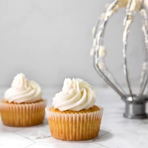 vegan frosting with no vegan butter piped onto vegan vanilla cupcakes