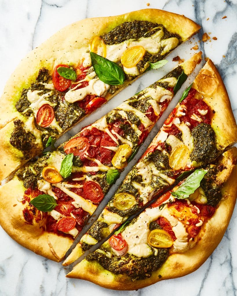 vegan tricolore pizza with liquid mozzarella, cut into long slices